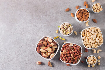 Healthy mix nuts on wooden background. Almonds, hazelnuts, cashews, peanuts, pistachios, Brazil nuts