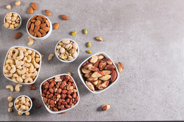 Healthy mix nuts on wooden background. Almonds, hazelnuts, cashews, peanuts, pistachios, Brazil nuts