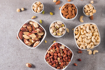 Healthy mix nuts on wooden background. Almonds, hazelnuts, cashews, peanuts, pistachios, Brazil nuts
