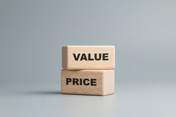 VALUE wood block placed on the top of PRICE wood block, value-based pricing strategy, value and...