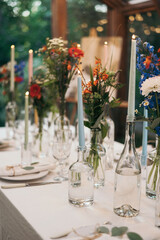 Decorated atmospheric table for a conservatory wedding. The concept of serving and decorating the holiday