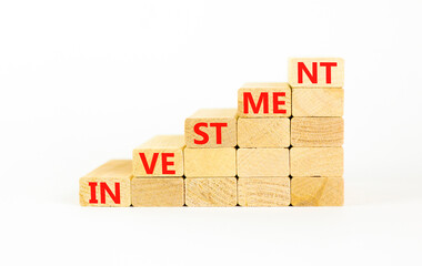 Investment symbol. Concept word Investment on beautiful wooden blocks. Beautiful white background....