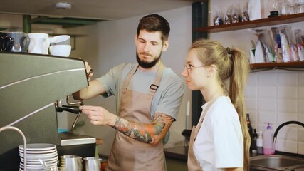 Two baristas focus on coffee preparation, demonstrating skill and teamwork in a modern caf setting, perfect for coffee culture enthusiasts and industry professionals