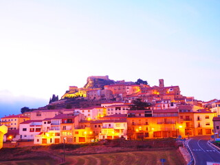 Obraz premium Culla, a village in Maestrazgo, Castellón, illuminated at dusk