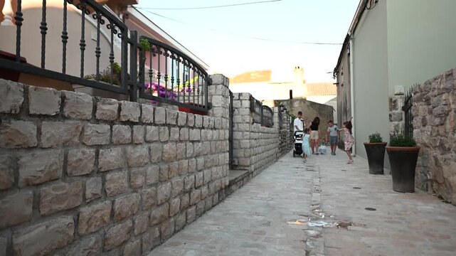 Two Happy Sisters Holding Hands Running Down European Street In Nin, Croatia.