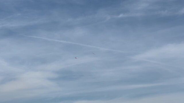 small passenger plane in flight tows a glider in the blue sky. High quality 4k footage