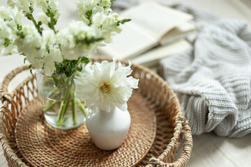 Cozy still life with white flowers. Home style and coziness.