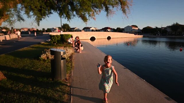 Family Enjoying a Summer Evening by the River In Nin Croatia.