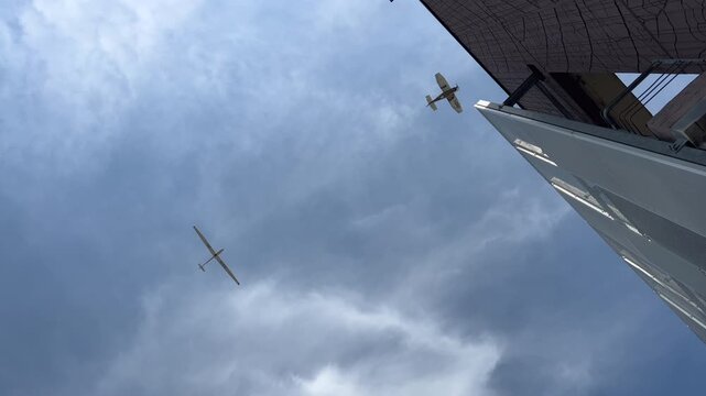 small passenger plane in flight tows a glider in the blue sky. High quality 4k footage