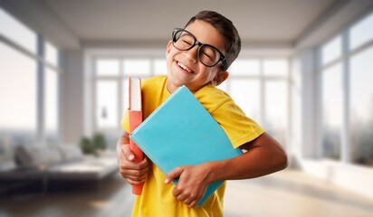 Happy small student boy in school classroom