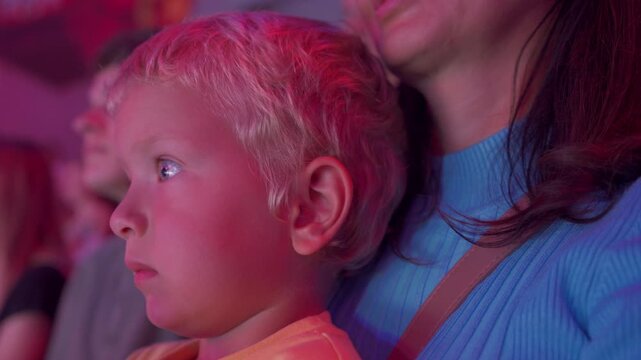 Spectators in a circus. Happy family with small child watching a circus performance. Little boy at circus. Simferopol, Crimea, Russia 2024