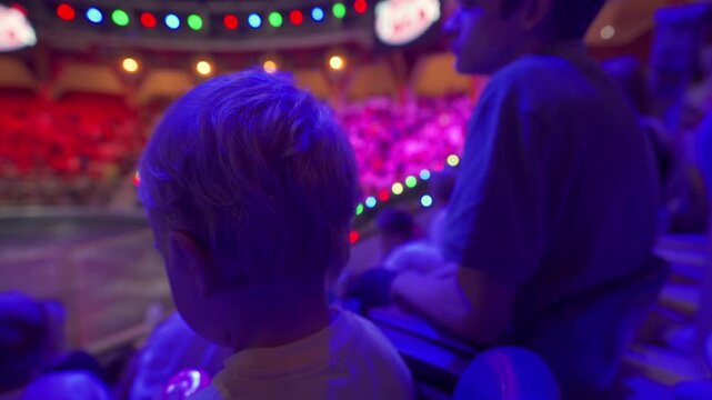 Spectators in a circus. Small child little boy watching a circus performance. Simferopol, Crimea, Russia 2024