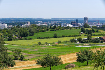 Scenic view of agriculture landscape with Glatt Valley and skyline with apartment towers in the...