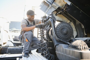 Professional african american truck mechanic working in vehicle repair service