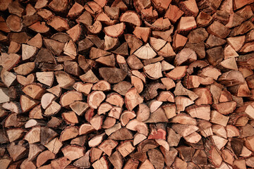 View of a Stack of Firewood. Background of Dry Chopped Logs in a Woodpile. Natural Texture. Preparation of Firewood for the Cold Winter