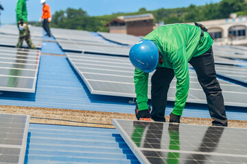 Worker Technicians are working to construct solar panels system on roof. Installing solar...
