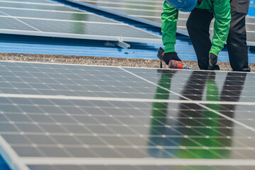 Worker Technicians are working to construct solar panels system on roof. Installing solar photovoltaic panel system. Men technicians walking on roof structure to check photovoltaic solar modules.