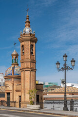 Obraz premium Castillo de San Jorge castle adjacent to the Isabel II bridge and market in Triana, Seville, Spain