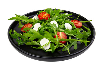 Mediterranean salad with arugula tomatoes and mozzarella on black plate . isolated on white