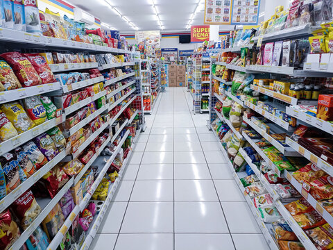 Aisle with various kinds of goods on the shelves inside Indomaret (one of Indonesia local franchice Mini market business unit). Bandung-Indonesia,July 31 2024