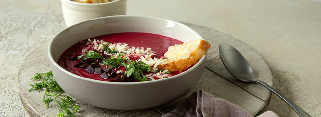 plate of creamy beet soup with parmesan croutons on the table