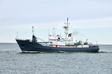 Russian warship armed with armament sails into sea toward military target to attack and destroy