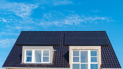 Modern Home With Solar Panels Harnessing Sunshine Under a Clear Blue Sky