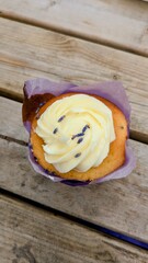 Lavender cupcake on wooden table. top view. Lavender field in England