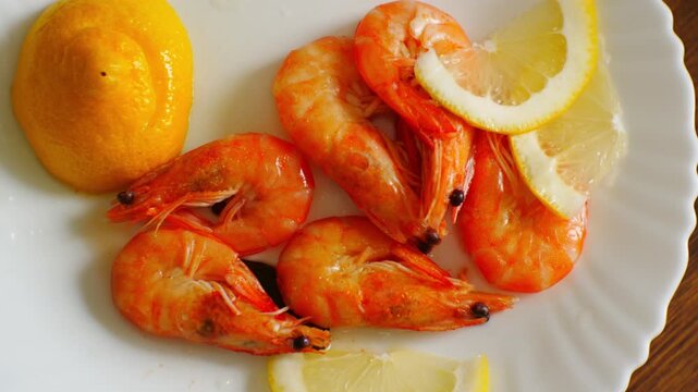 Microwavable meal. Calorie restriction in human nutrition. Boiled shrimps in shell with sliced lemon. Mediterranean low-calorie diet to combat obesity
