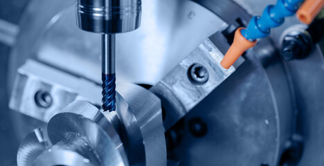 Modern CNC milling machine during operation, blue toning. Produced cutting metal parts, industry heavy factory