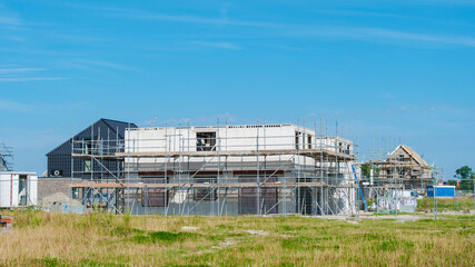 Modern Family Houses Rising in Dutch Suburban Construction Site Under a Clear Sky