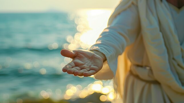 Jesus in White Robe Extending an Open Hand by a Sunlit Sea at Sunset