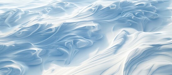 Obraz premium Top view of a mesmerizing snowy landscape with intricate wind sculpted patterns on the snow Ideal for backgrounds and designs featuring a wide panoramic copy space image
