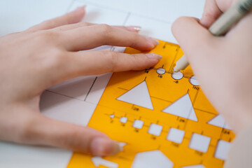 The architect used a pencil, ruler, and compass to meticulously create the blueprint, ensuring...