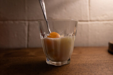 A glass of milk with soft-boiled egg.