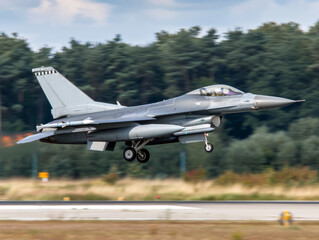 A fighter jet is taking off from a runway