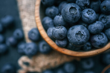 Blueberries background. Blueberry border design. Ripe and juicy fresh picked bilberries close up. Copyspace for your text