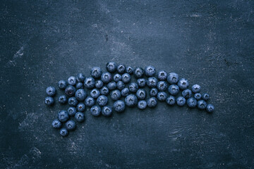 Blueberries background. Blueberry border design. Ripe and juicy fresh picked bilberries close up. Copyspace for your text