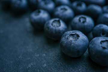 Blueberries background. Blueberry border design. Ripe and juicy fresh picked bilberries close up. Copyspace for your text