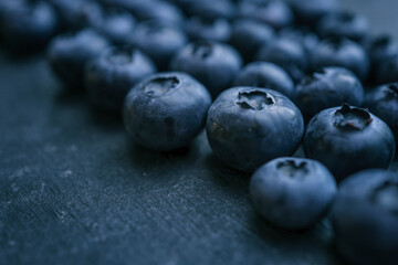 Blueberries background. Blueberry border design. Ripe and juicy fresh picked bilberries close up. Copyspace for your text