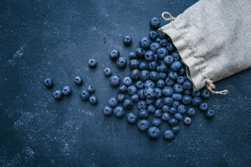 Blueberries background. Blueberry border design. Ripe and juicy fresh picked bilberries close up. Copyspace for your text