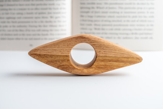 hand made crafted hardwood book page holder isolated against a book page