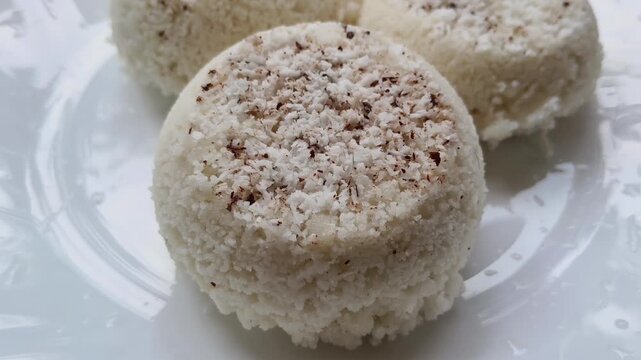 Steamed rice cake, puttu, pittu or putt popular traditional native vegetarian dish for breakfast and dinner in south Indian states Karnataka, Tamil Nadu and Kerala. Closeup macro top side view.