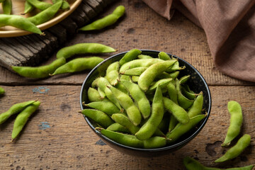 Raw uncooked green soybeans (edamame).Healthy snacks in a bowl