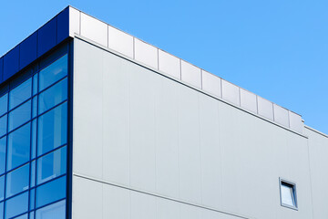 factory office architecture building exterior outdoor facade blue wall and window with blue sky background with empty copy space for text