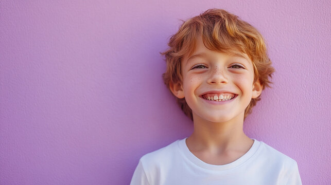 Cheerful boy against a soft lilac background