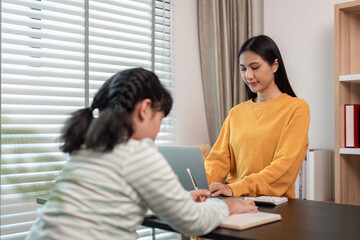 Mother and Child Working from Home Together in a Modern Home Office Setting with Natural Light