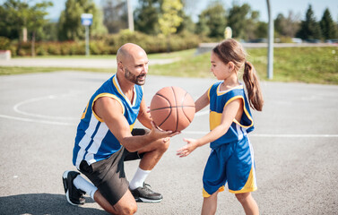 Fototapeta premium Basketball, sport with a dad and daughter training on a court outside for leisure fitness and fun