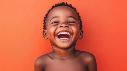 Laughing boy with a light peach background
