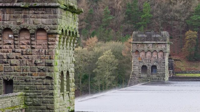 Views of the famous Howden and Derwent stone build Dams, used in the filming of the movie Dam Busters. Showing water overflowing over the dam walls with victorian towers on each side of the structure